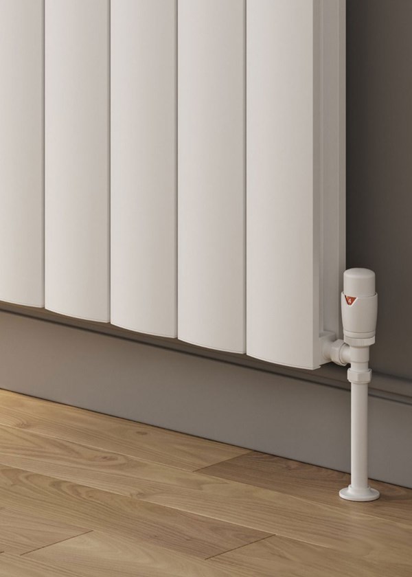 Reina Loco finished in White - Close-Up - Shown with Reina Modal Thermostatic Radiator Valves, angled, White finish and White Pipe Sleeves and Shrouds Reina Loco finished in White - Close-Up - Shown with Reina Modal Thermostatic Radiator Valves, angled, White finish and White Pipe Sleeves and Shrouds