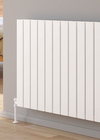 Reina Piatto finished in White - Close-Up - Shown with Reina Modal Thermostatic Radiator Valves, angled, Anthracite finish and Anthracite Pipe Sleeves and Shrouds